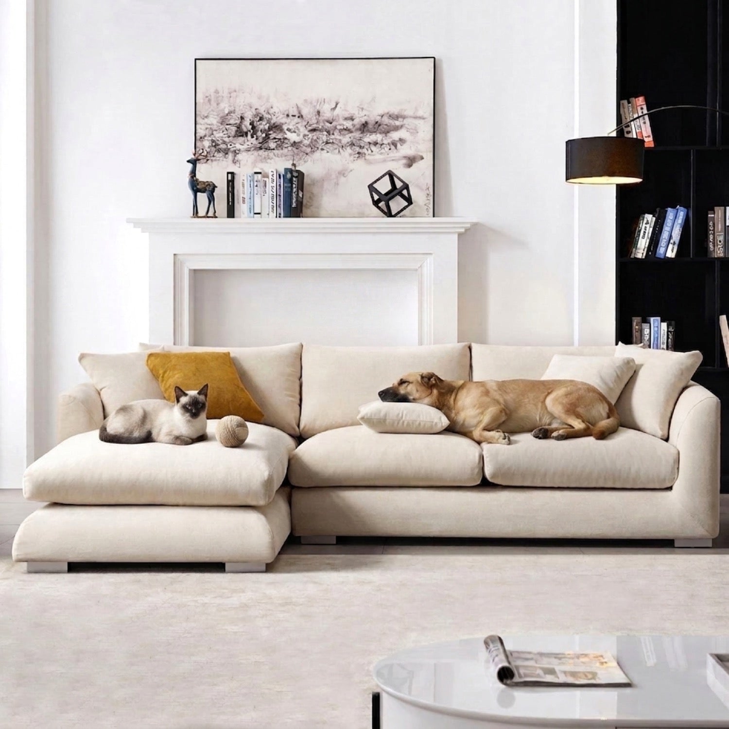 Beige Feathers Sectional sofa with a chaise lounge on the left, featuring a dog sleeping on a cushion, a small dog with a toy, and a cat on the backrest in a living room setting.