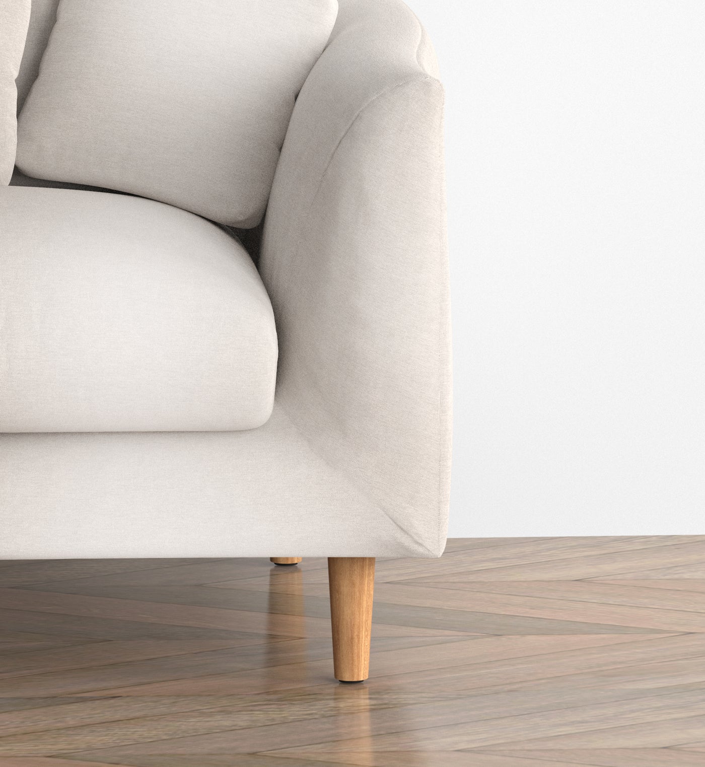 Close view of ivory Feathers upholstery and a natural ash wood leg