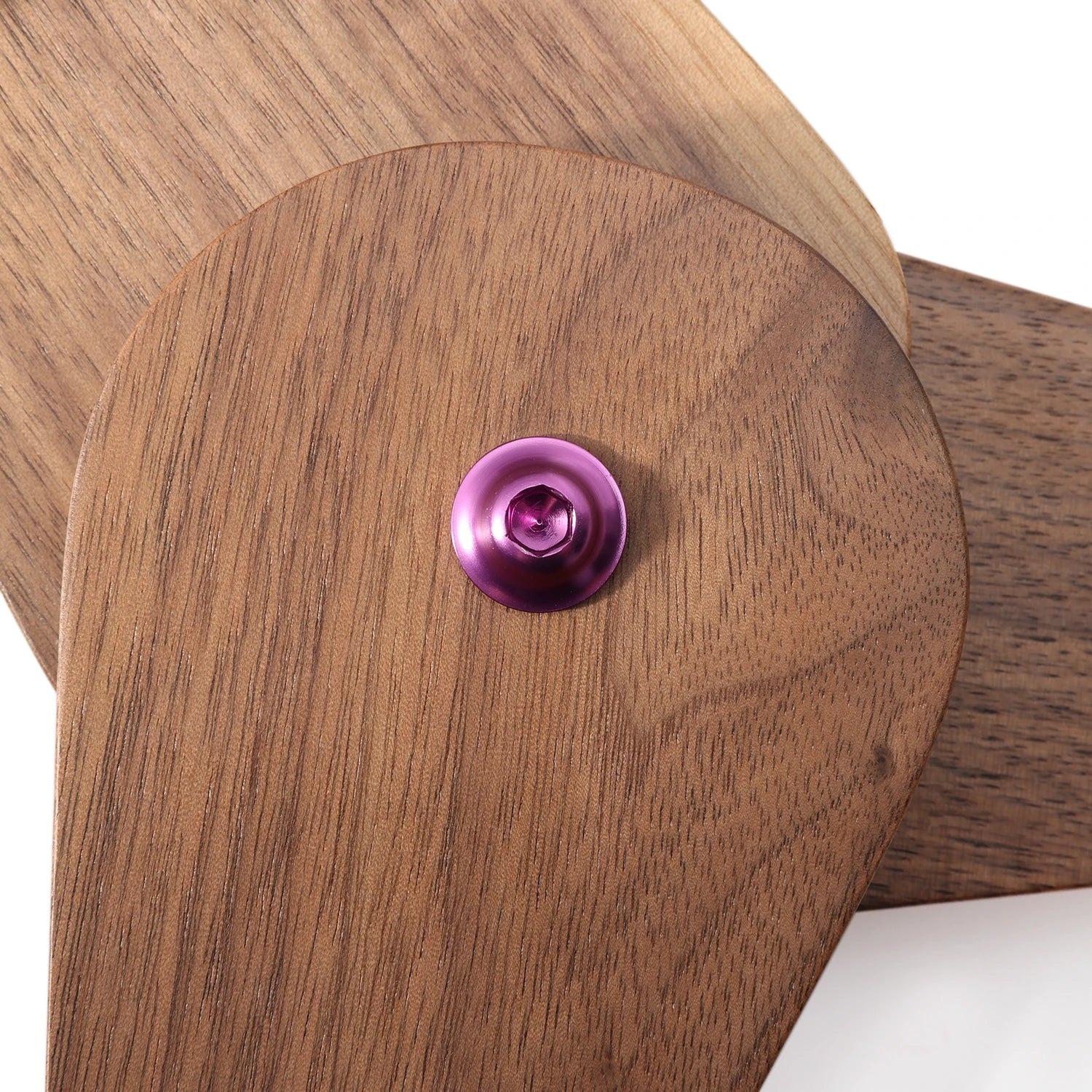 Wooden object with a purple button on a white background