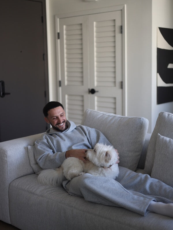 A customer relaxing with his dog on a Valyou sofa