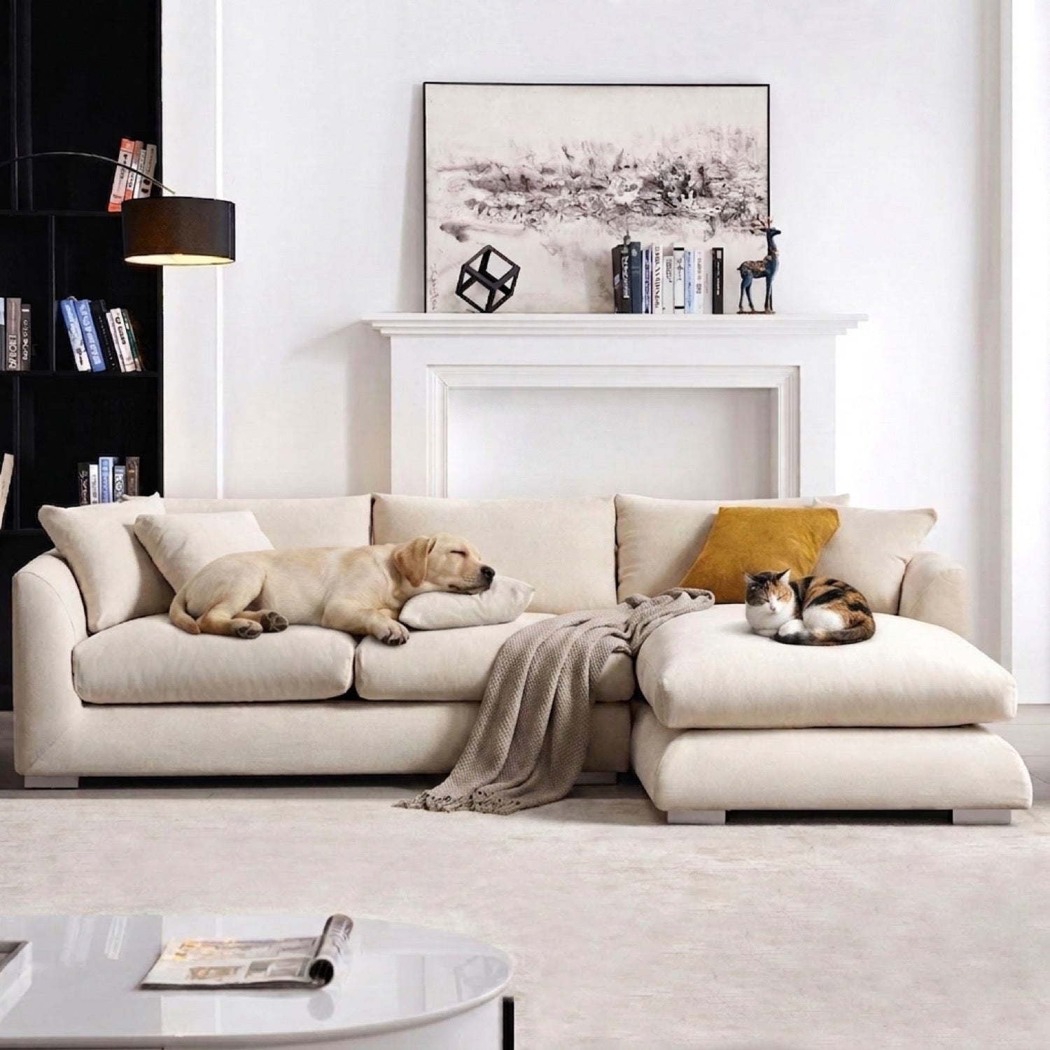 Beige sectional sofa with a dog sleeping on a cushion and a cat on the chaise lounge in a living room.