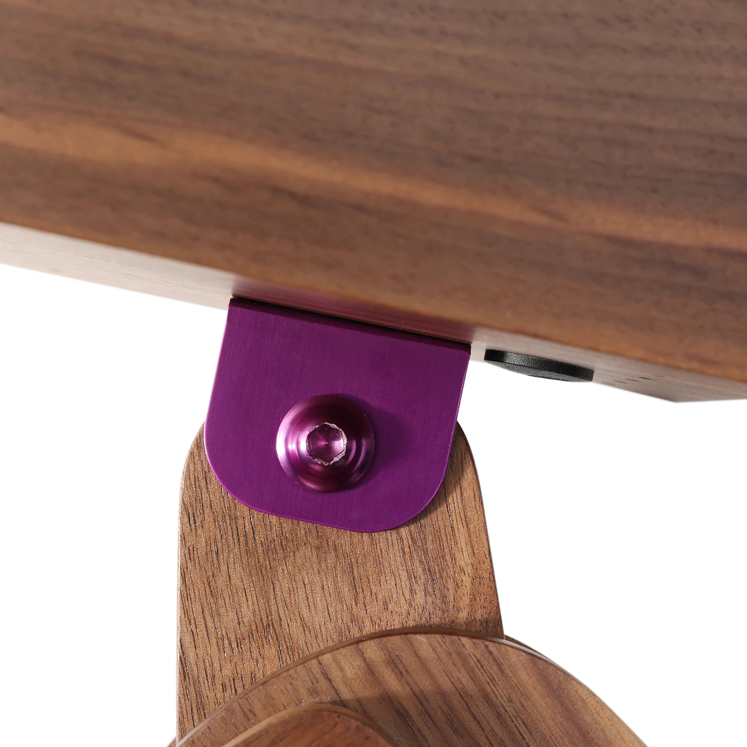 Close-up of a wooden chair with a purple metal bracket on a white background