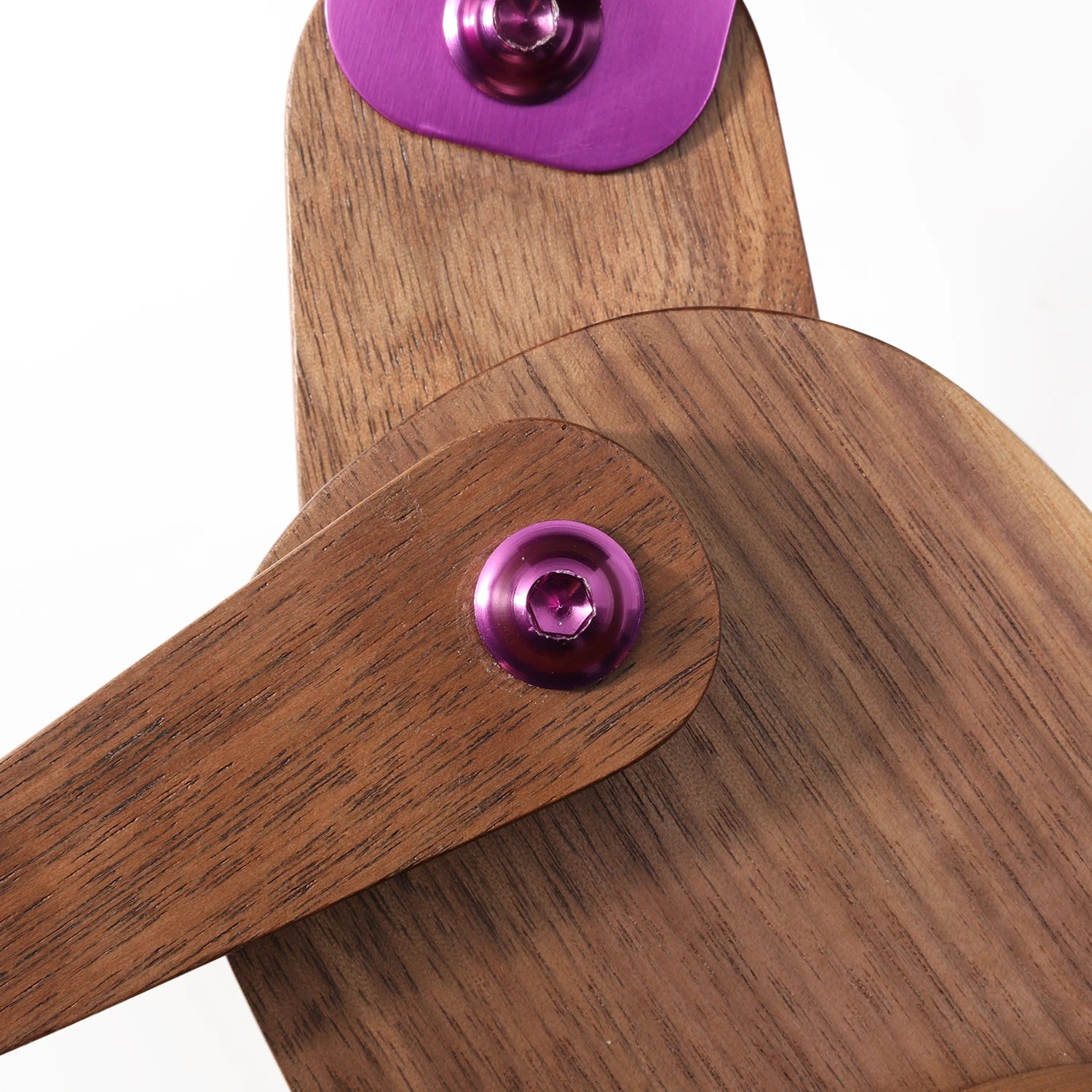 Wooden object with purple circular components on a white background