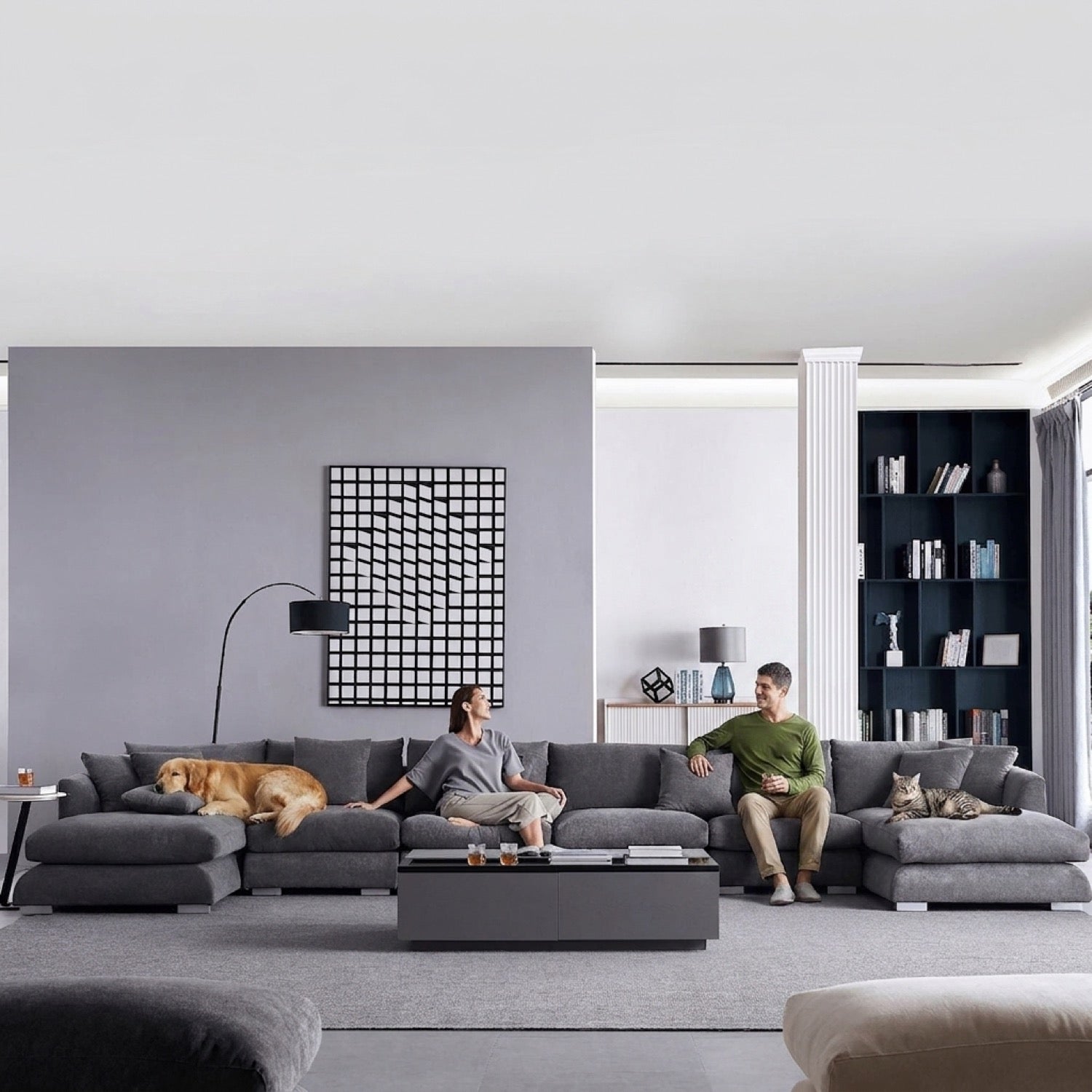 Grey Feathers U-Sectional sofa in a modern living room with a woman, a man, a dog, and a cat