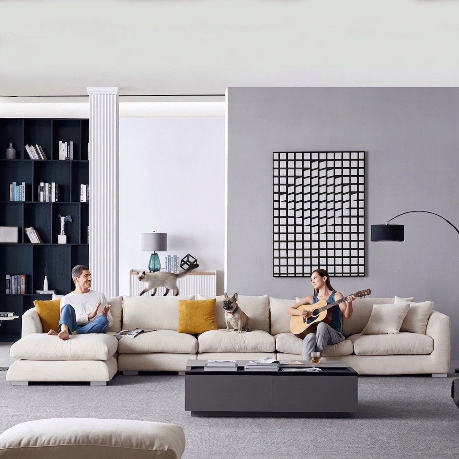 Beige sectional sofa with a left-facing chaise in a modern living room with a man, woman, and cat