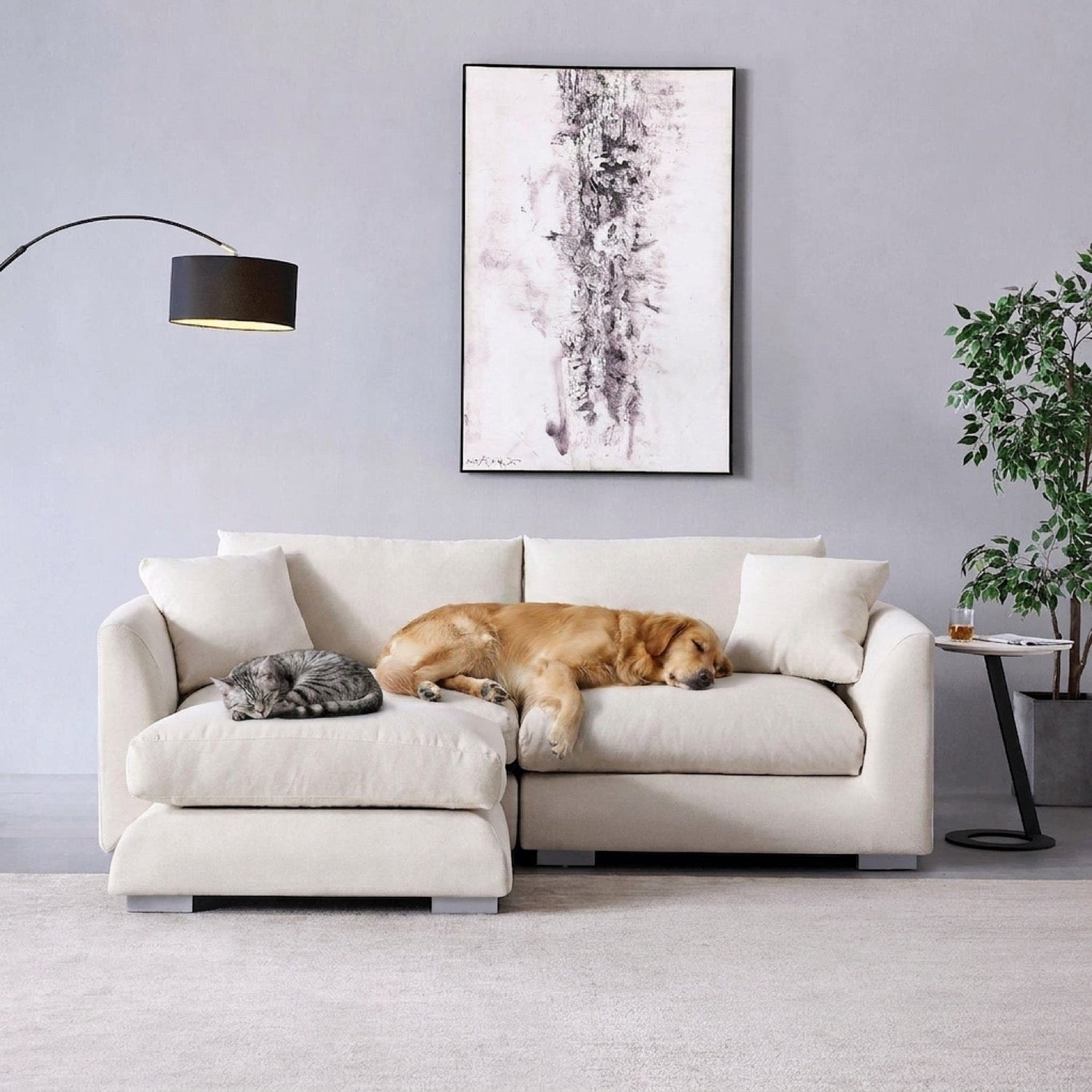 Beige sectional sofa with a chaise lounge, a floor lamp, and a plant in a modern living room setting